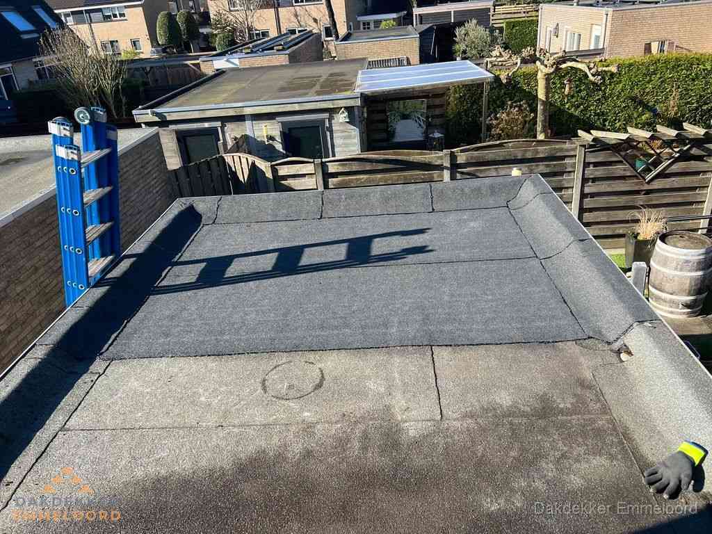 Dakdekker legt onderlaag op plat dak met houten constructie in Emmeloord